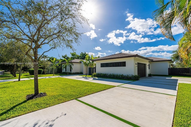 ranch-style house featuring a garage and a front yard