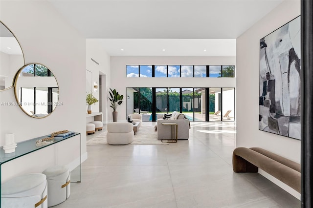 living room with a wealth of natural light and a high ceiling