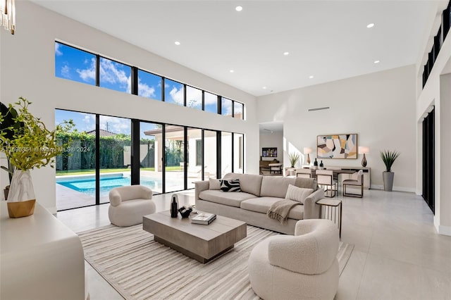 living room featuring light tile patterned floors and a high ceiling