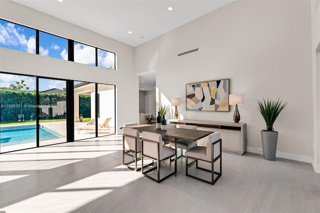 dining room with a towering ceiling