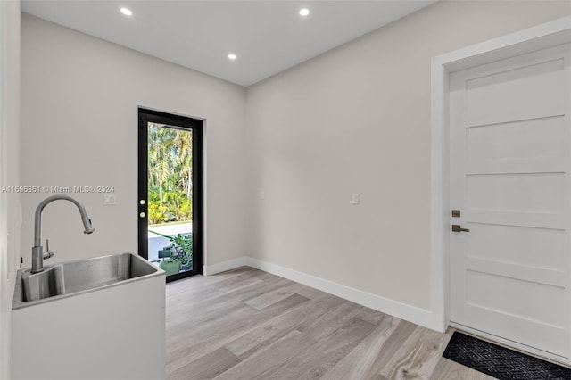 interior space featuring light wood-type flooring and sink