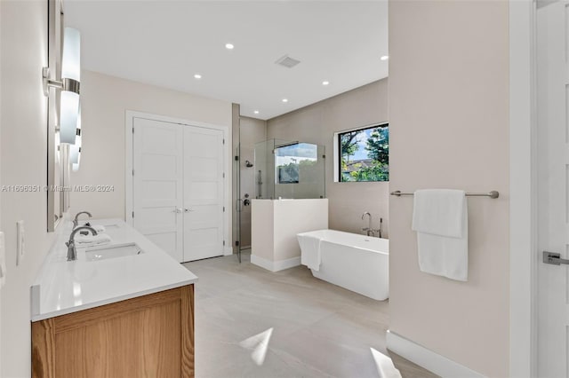 bathroom featuring vanity and shower with separate bathtub