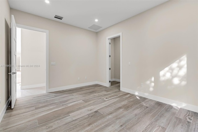 unfurnished room with light hardwood / wood-style flooring