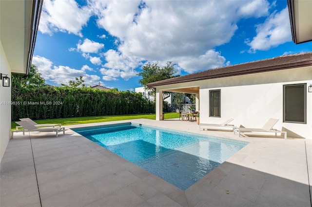 view of pool featuring a yard and a patio