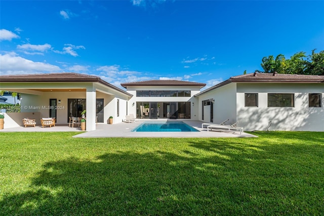 rear view of house with a patio area and a yard