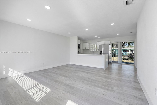 unfurnished living room with light hardwood / wood-style flooring