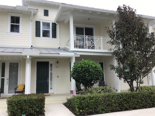 view of exterior entry with a balcony