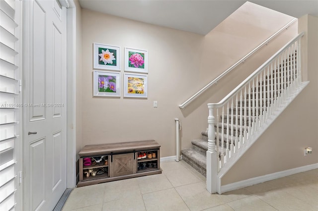 stairway with tile patterned floors