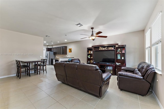 tiled living room with ceiling fan