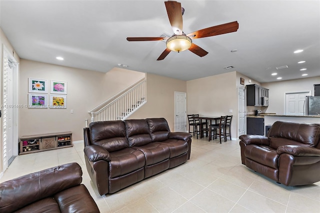 living room featuring ceiling fan and light tile patterned flooring