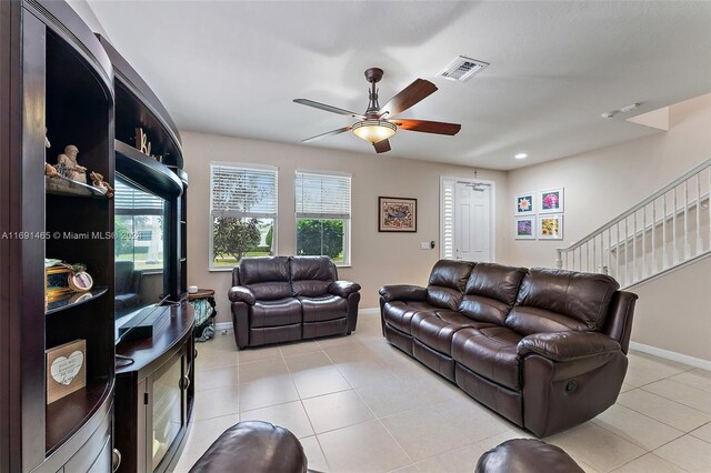 living room with ceiling fan and light tile patterned floors