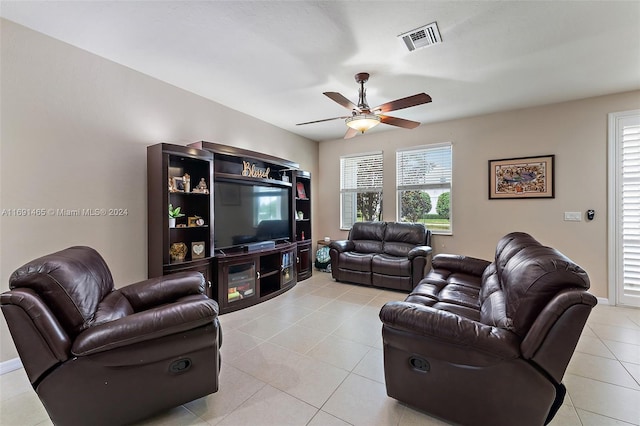 tiled living room featuring ceiling fan