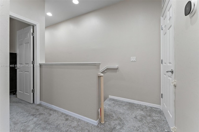 hallway featuring light colored carpet