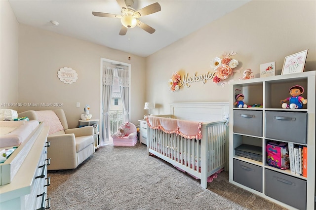 bedroom with ceiling fan, carpet, and a crib