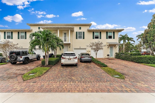 view of front of house with a garage and a balcony