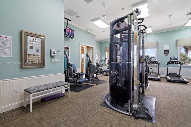 gym featuring carpet and ornamental molding