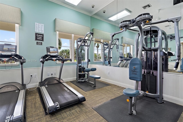 workout area featuring crown molding