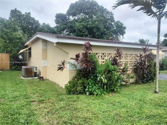 view of home's exterior with a yard and cooling unit