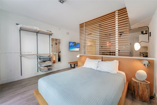 6080 Collins Ave Unit 102, Miami Beach, FL 33140 - bedroom with wood finished floors and baseboards