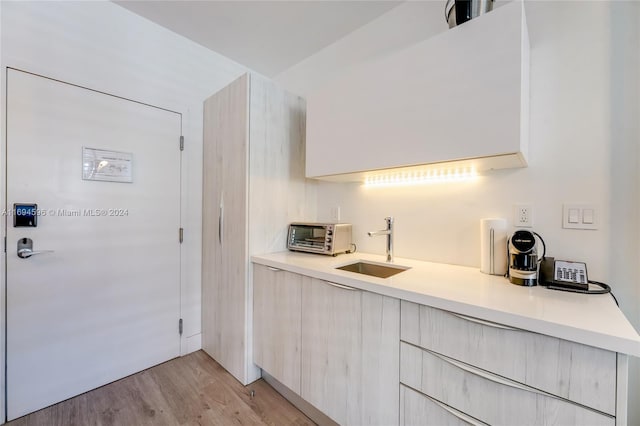 kitchen featuring sink and light hardwood / wood-style flooring