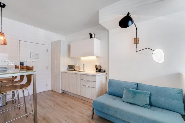 interior space featuring light hardwood / wood-style floors and hanging light fixtures