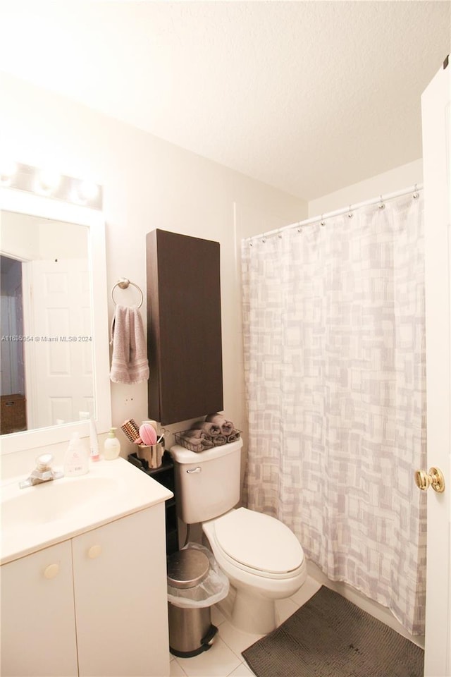 bathroom featuring walk in shower, a textured ceiling, vanity, tile patterned flooring, and toilet