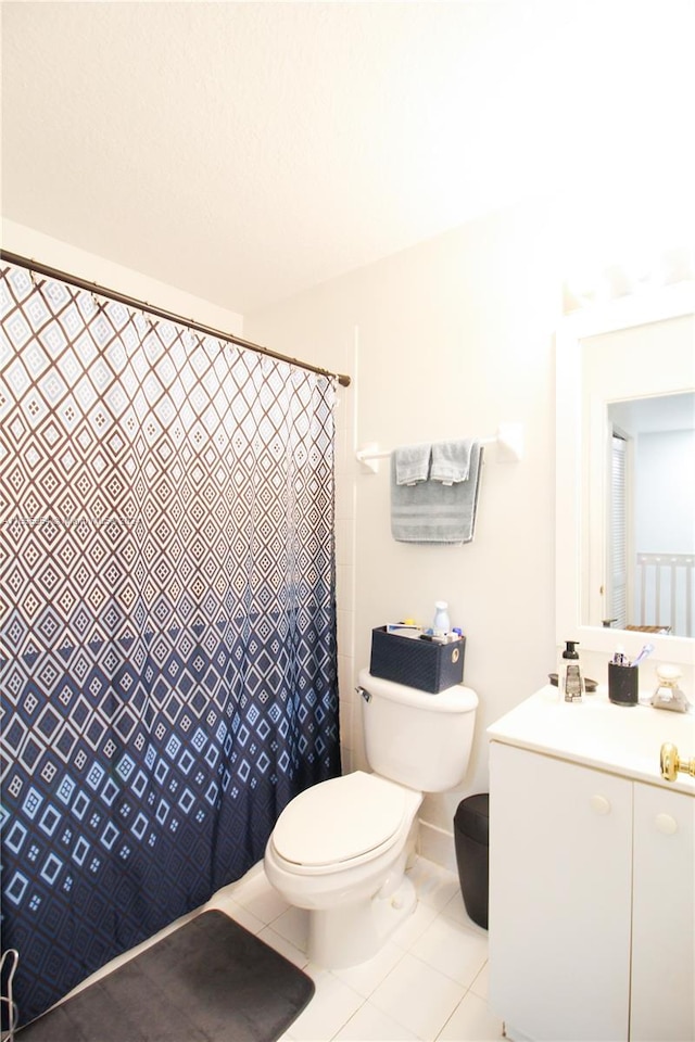 bathroom with a shower with curtain, tile patterned flooring, and toilet