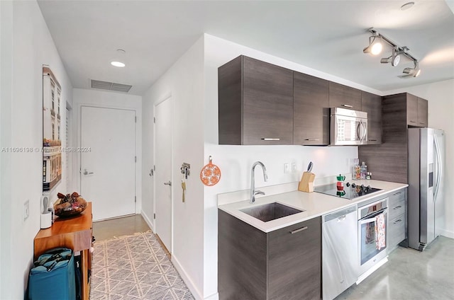 kitchen featuring dark brown cabinets, stainless steel appliances, and sink