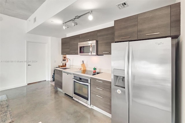 kitchen with dark brown cabinetry, sink, and stainless steel appliances