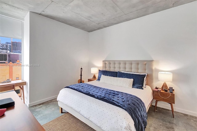 bedroom featuring concrete floors