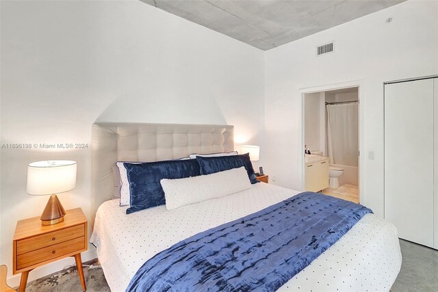 carpeted bedroom featuring connected bathroom