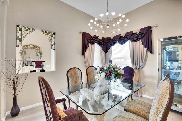 dining space with a notable chandelier and light tile patterned floors