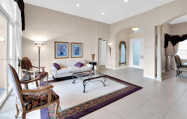 tiled living room featuring decorative columns