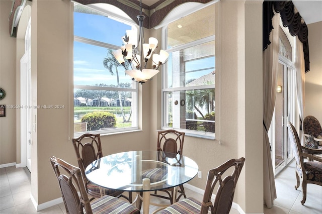 tiled dining space featuring a chandelier