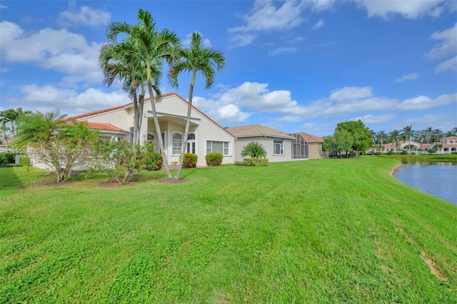 view of front facade with a water view and a front yard