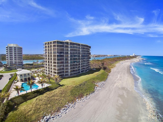 drone / aerial view with a beach view and a water view