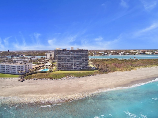 aerial view with a water view and a beach view