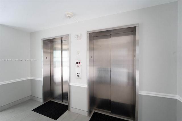 interior space featuring tile patterned flooring and elevator