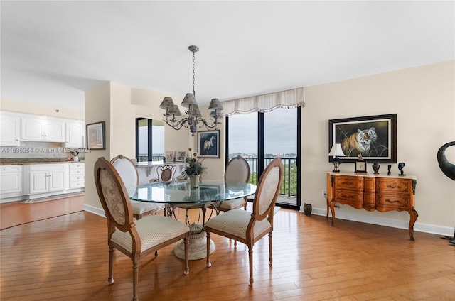 dining area featuring a chandelier and light hardwood / wood-style floors