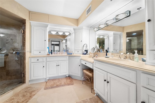 bathroom with tile patterned flooring, vanity, and an enclosed shower