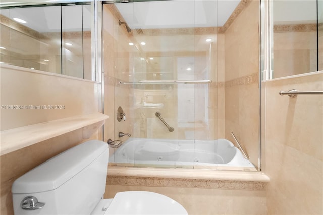 bathroom with shower / bath combination with glass door and toilet