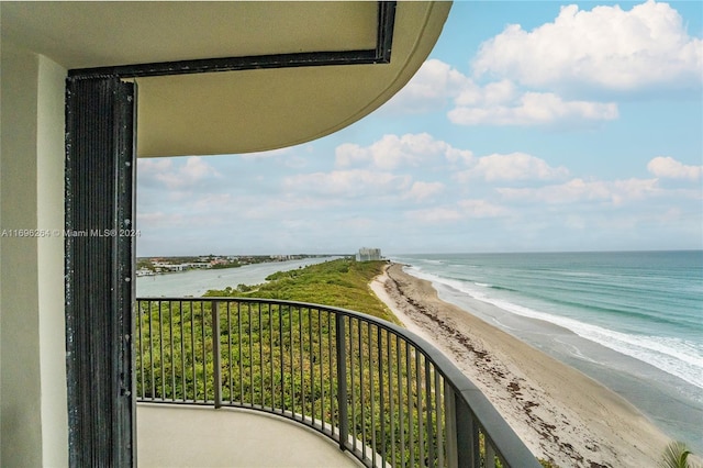 balcony featuring a water view and a view of the beach