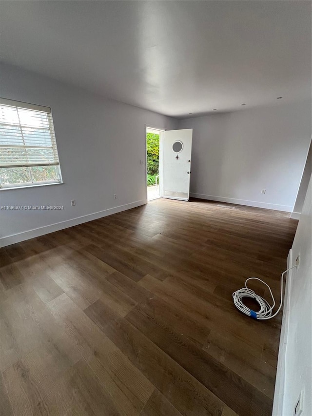 interior space with plenty of natural light and dark hardwood / wood-style floors