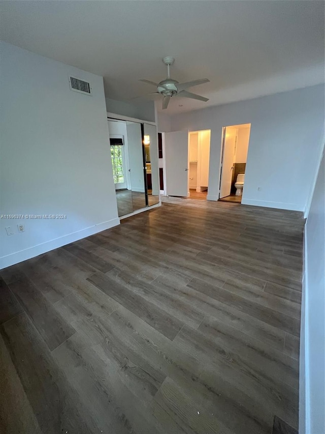 spare room featuring ceiling fan and dark hardwood / wood-style flooring