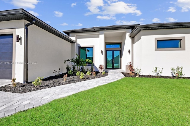 exterior space with a lawn, french doors, and a garage