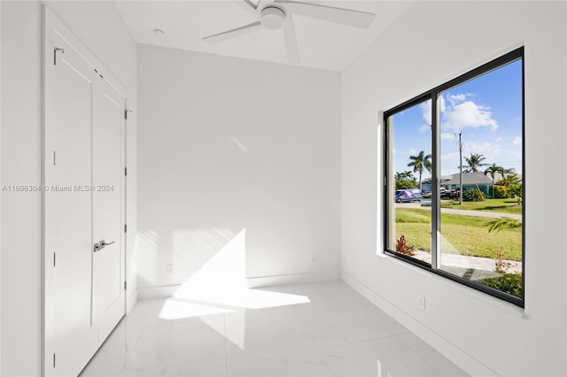 bedroom with multiple windows and ceiling fan