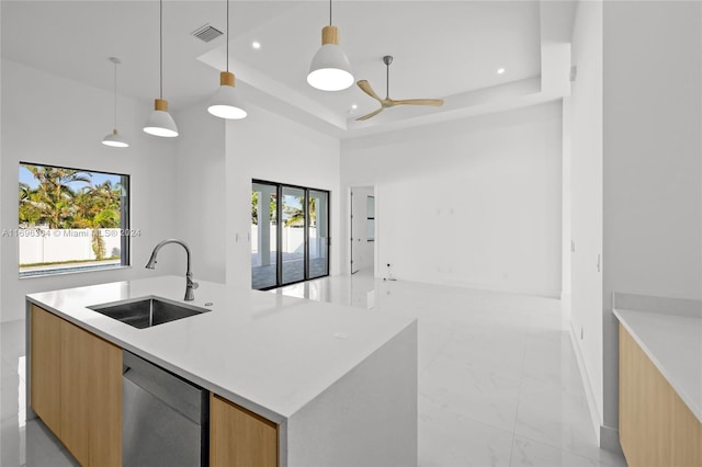 kitchen with pendant lighting, a healthy amount of sunlight, and sink