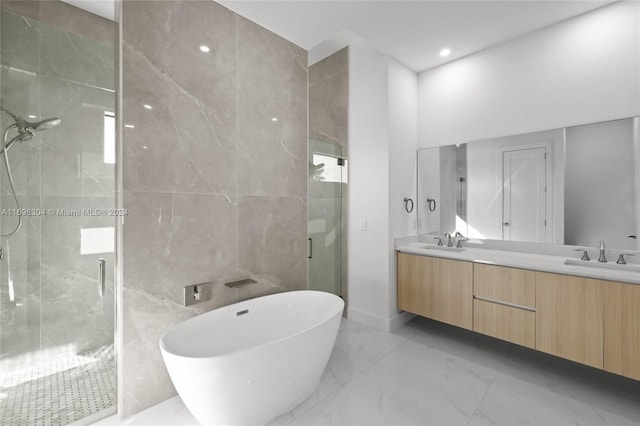 bathroom with vanity, tile walls, and independent shower and bath