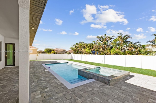 view of swimming pool with an in ground hot tub and a patio