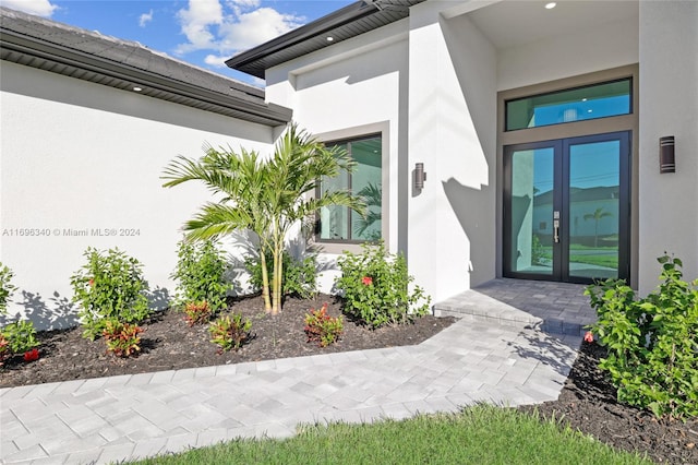 view of exterior entry featuring french doors